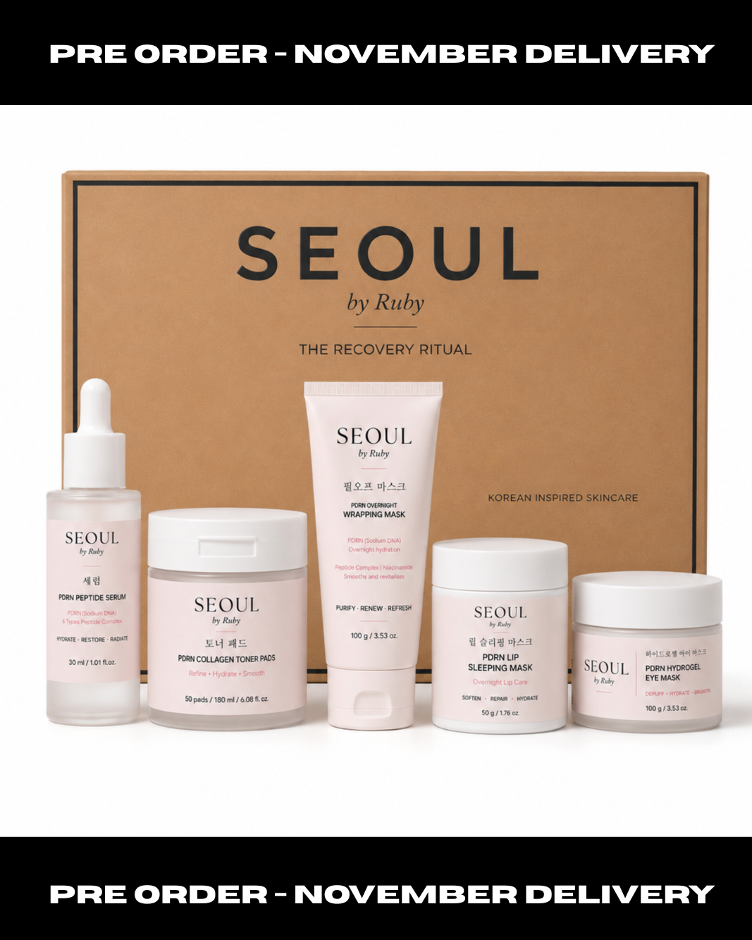 A skincare set from SEOUL by Ruby displayed in front of a brown cardboard box. The set includes a serum dropper bottle, a hydrating mask cream jar, a deep cleansing face wash jar, a blue-enzyme mask cream jar, and an eye cream jar, all in soft pink packaging.